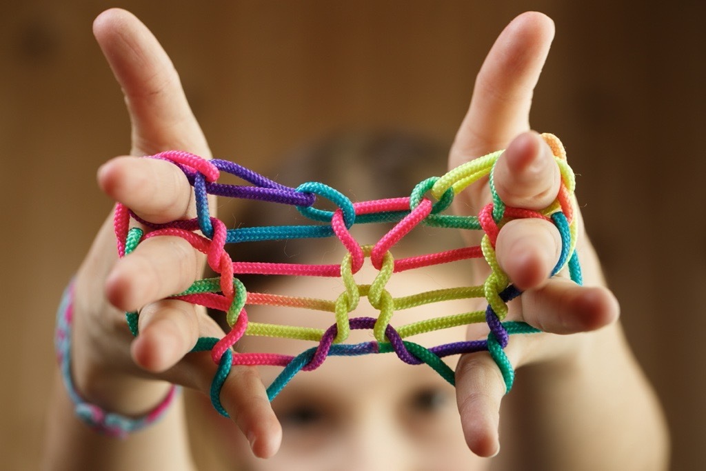 Girl playing classic string game, creating shapes